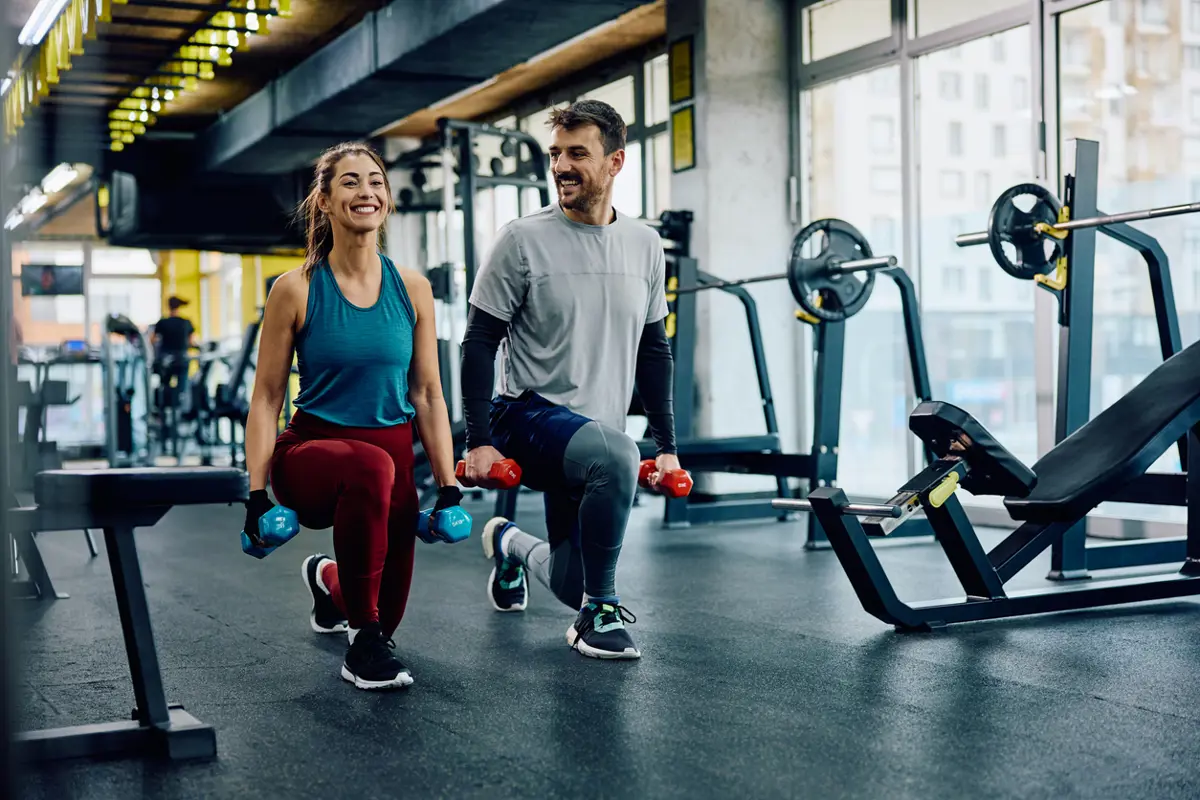 Man en vrouwen sporten in sportschool